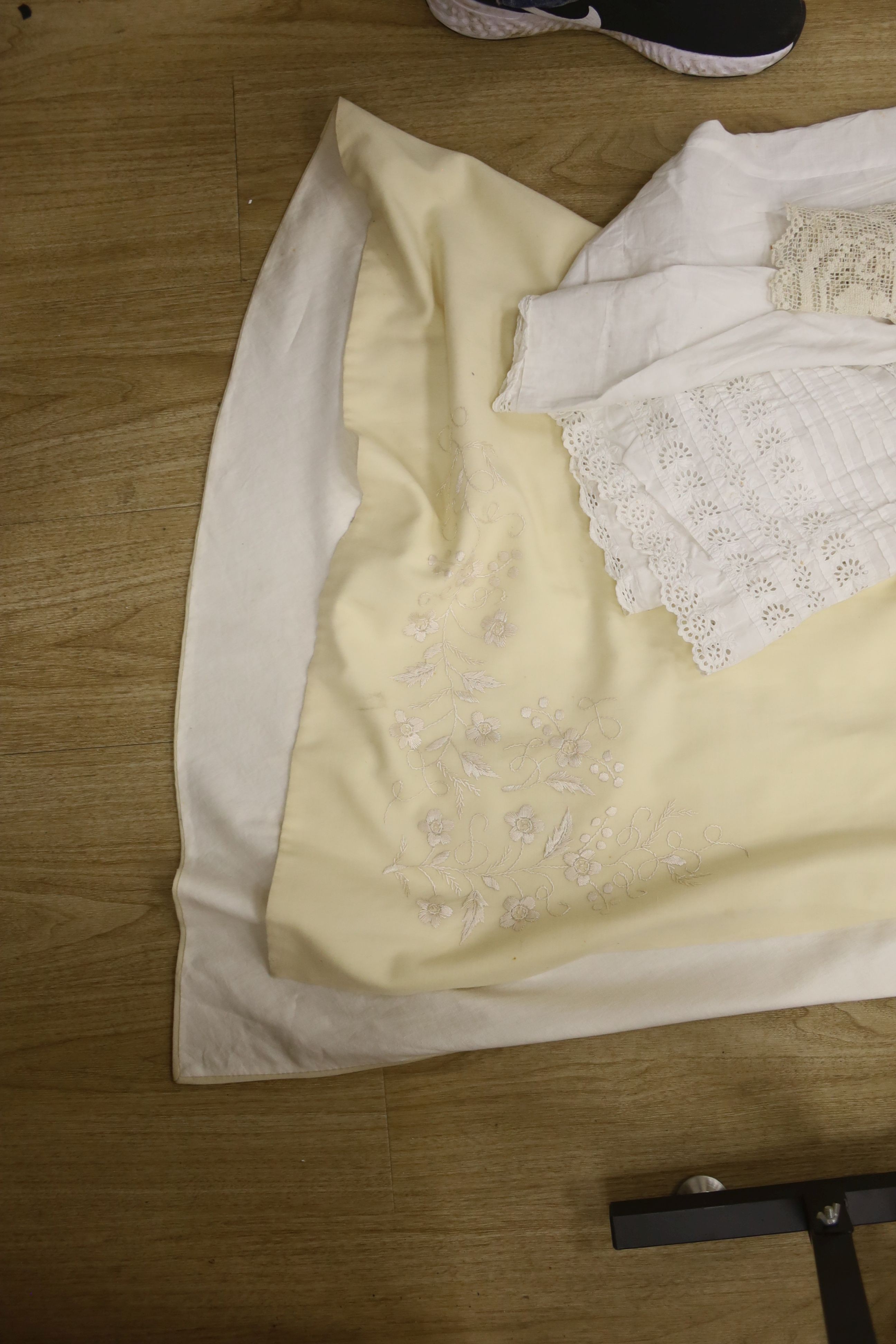 A 19th century embroidery anglais christening gown and nun's veiling cape, together with a small collection of tablecloths, etc